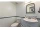 Small bathroom with toilet, sink, and decorative mirror at 225 N Standage -- # 122, Mesa, AZ 85201