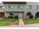 Light green stucco exterior of a townhome with a well-manicured lawn at 225 N Standage -- # 122, Mesa, AZ 85201