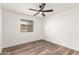 Well-lit bedroom with wood-look floors and ceiling fan at 2407 E Encanto St, Mesa, AZ 85213