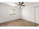 Bedroom with wood-look floors and ceiling fan at 2407 E Encanto St, Mesa, AZ 85213