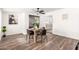 Dining room with wood-look floors and a modern dining table at 2407 E Encanto St, Mesa, AZ 85213