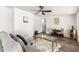 Living room with wood-look floors, comfy seating, and a glass coffee table at 2407 E Encanto St, Mesa, AZ 85213