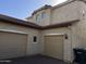 Two-story home exterior with two-car garage and light colored stucco at 2431 N 83Rd Dr, Phoenix, AZ 85037