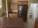 Kitchen with stainless steel refrigerator and pantry at 2431 N 83Rd Dr, Phoenix, AZ 85037