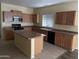 Kitchen with island and stainless steel appliances at 2431 N 83Rd Dr, Phoenix, AZ 85037