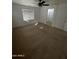 Large main bedroom with carpeted flooring and an ensuite bathroom at 2431 N 83Rd Dr, Phoenix, AZ 85037