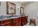 Double vanity bathroom with granite countertop and dark wood cabinets at 250 E Voltaire Ave, Phoenix, AZ 85022