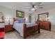 Comfortable bedroom with wood furniture, ceiling fan, and tile floor at 250 E Voltaire Ave, Phoenix, AZ 85022