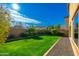 Landscaped backyard with grassy area and gravel border at 25719 N 54Th Dr, Phoenix, AZ 85083