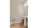 Stylish powder room with pedestal sink and mirror at 25719 N 54Th Dr, Phoenix, AZ 85083