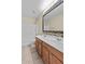 Bright bathroom featuring a double sink vanity, decorative mirror, and a shower with white tiled walls at 29061 N Cactus Cir, San Tan Valley, AZ 85143