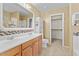 Bathroom with double vanity, large mirror, and walk-in closet at 29061 N Cactus Cir, San Tan Valley, AZ 85143