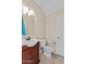 Well-lit bathroom with vanity, toilet, neutral walls, and a bright white door at 29061 N Cactus Cir, San Tan Valley, AZ 85143