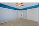 Well-lit bedroom, featuring a ceiling fan and double closet at 29061 N Cactus Cir, San Tan Valley, AZ 85143