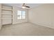 Light-filled carpeted bedroom with built-in shelving and a bright window at 29061 N Cactus Cir, San Tan Valley, AZ 85143