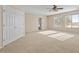 Carpeted bedroom with large windows, ceiling fan, and a large walk-in closet at 29061 N Cactus Cir, San Tan Valley, AZ 85143