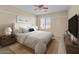 Bedroom featuring an expansive bed, neutral tones and a ceiling fan at 29061 N Cactus Cir, San Tan Valley, AZ 85143