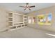 Gathering room with built-in shelving and a ceiling fan at 29061 N Cactus Cir, San Tan Valley, AZ 85143