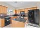 Bright kitchen featuring an island, wooden cabinets, and stainless steel appliances at 29061 N Cactus Cir, San Tan Valley, AZ 85143