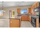 Spacious kitchen with an island, wood cabinets, and tile flooring at 29061 N Cactus Cir, San Tan Valley, AZ 85143