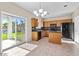 Well-lit kitchen with a sliding glass door to patio; featuring wooden cabinets and black appliances at 29061 N Cactus Cir, San Tan Valley, AZ 85143