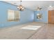 Living room with light blue walls, carpeted floor and wood-look tile at 29061 N Cactus Cir, San Tan Valley, AZ 85143