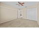 Carpeted main bedroom with a ceiling fan and multiple entryways at 29061 N Cactus Cir, San Tan Valley, AZ 85143