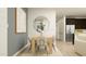 Dining area with light wood table and gray accent wall at 29403 N 31St Ln, Phoenix, AZ 85083