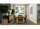 Modern dining room with a wood table, six chairs and blue accent wall at 29415 N 31St Ln, Phoenix, AZ 85083