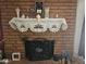 Brick fireplace with decorative mantle and screen at 297 Peretz Cir, Morristown, AZ 85342