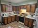 Galley kitchen with wood cabinets and tile floor at 297 Peretz Cir, Morristown, AZ 85342