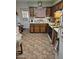 Galley kitchen with wood cabinets and tile floor at 297 Peretz Cir, Morristown, AZ 85342