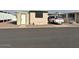 Tan mobile home with green trim, and a carport at 300 S Val Vista Dr # 77, Mesa, AZ 85204