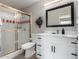 Updated bathroom with white vanity, gold shower, and red and white tile at 3808 W Mission Ln, Phoenix, AZ 85051