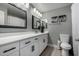 Modern bathroom with white cabinets, dual sinks, and large mirrors at 3808 W Mission Ln, Phoenix, AZ 85051