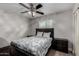 Guest bedroom with a queen bed, dark wood furniture, and a ceiling fan at 3808 W Mission Ln, Phoenix, AZ 85051