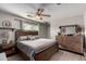 Spacious main bedroom with wood furniture and ceiling fan at 3808 W Mission Ln, Phoenix, AZ 85051