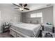 Bright bedroom featuring a king-size bed, crib, and ceiling fan at 3808 W Mission Ln, Phoenix, AZ 85051