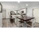 Modern kitchen with white cabinets, island, and dining area at 3808 W Mission Ln, Phoenix, AZ 85051