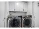 Laundry room with LG washer and dryer, and white cabinets at 3808 W Mission Ln, Phoenix, AZ 85051