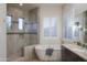 Bathroom with a walk-in shower and a soaking tub at 39005 N 11Th Ave, Phoenix, AZ 85086