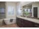 Elegant bathroom with a soaking tub and double vanity at 39005 N 11Th Ave, Phoenix, AZ 85086