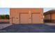 Large double garage doors and exterior lighting at 39005 N 11Th Ave, Phoenix, AZ 85086