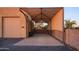 Covered parking area with brick pavers and a spacious garage door at 39005 N 11Th Ave, Phoenix, AZ 85086