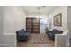 Bright sitting room with two sofas, a bookcase, and wood floors at 39005 N 11Th Ave, Phoenix, AZ 85086