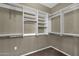 Spacious walk-in closet with built-in shelves and rods at 3935 E Rough Rider Rd # 1076, Phoenix, AZ 85050