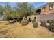 Side view of the townhouse with landscaping and a grassy area at 3935 E Rough Rider Rd # 1076, Phoenix, AZ 85050