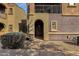 Townhome entrance with archway and landscaping at 3935 E Rough Rider Rd # 1076, Phoenix, AZ 85050