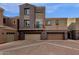 Three-story townhome with attached two-car garage and Spanish-style architecture at 3935 E Rough Rider Rd # 1076, Phoenix, AZ 85050