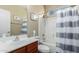 Bathroom with shower/tub combo, wood vanity, and striped curtain at 3946 E Pollack St, Phoenix, AZ 85042